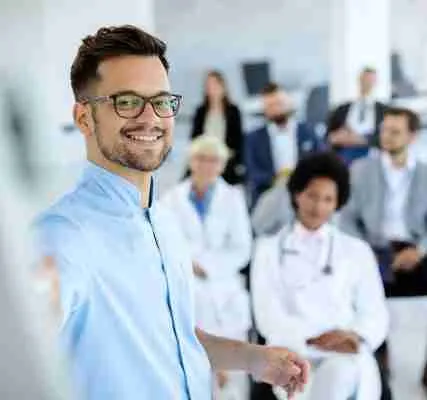 Happy businessman giving a presentation to group of colleagues a